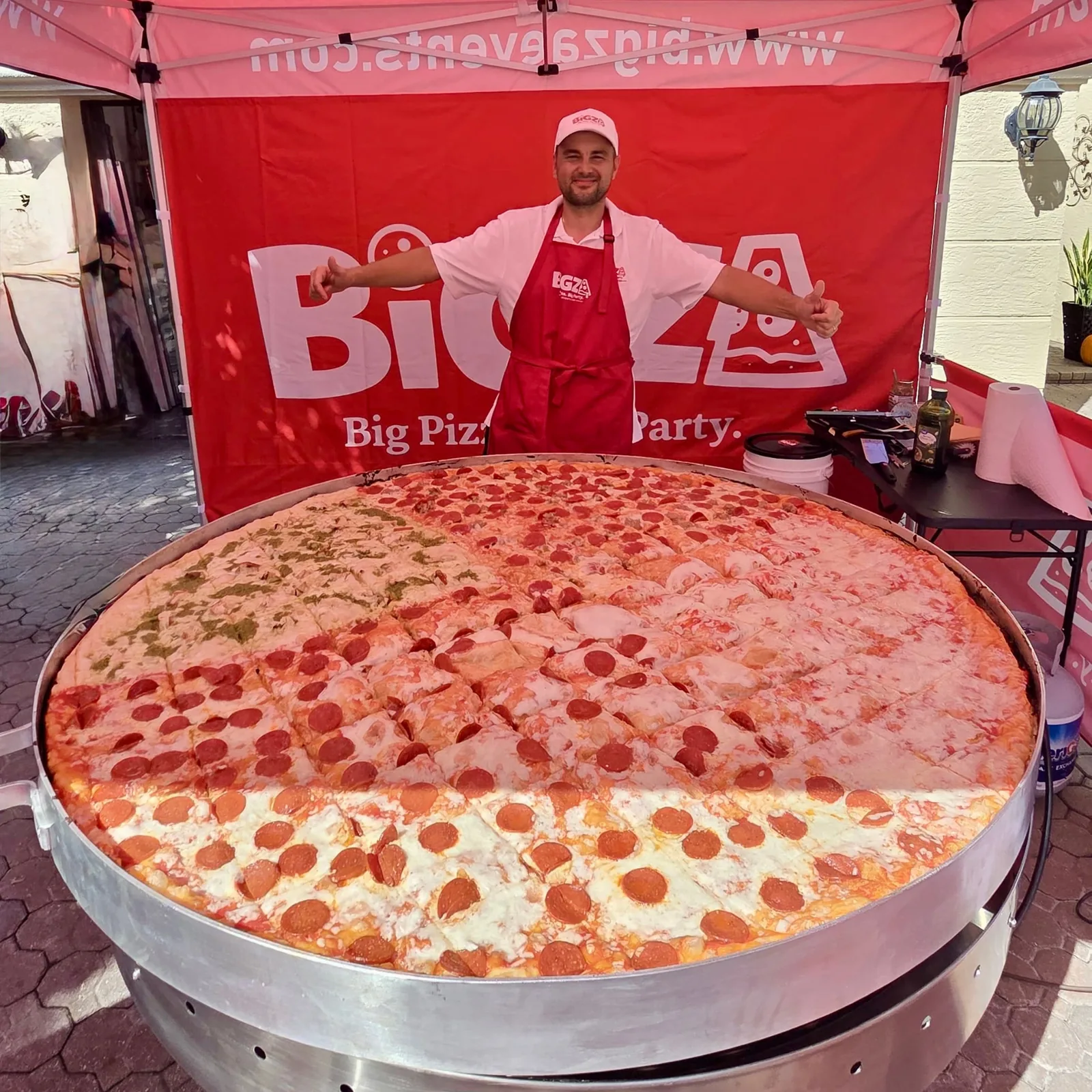 How big is Bigza? Size comparisons showing the 5-foot pizza next to a banana, an adult, a car and more — 1 of 4