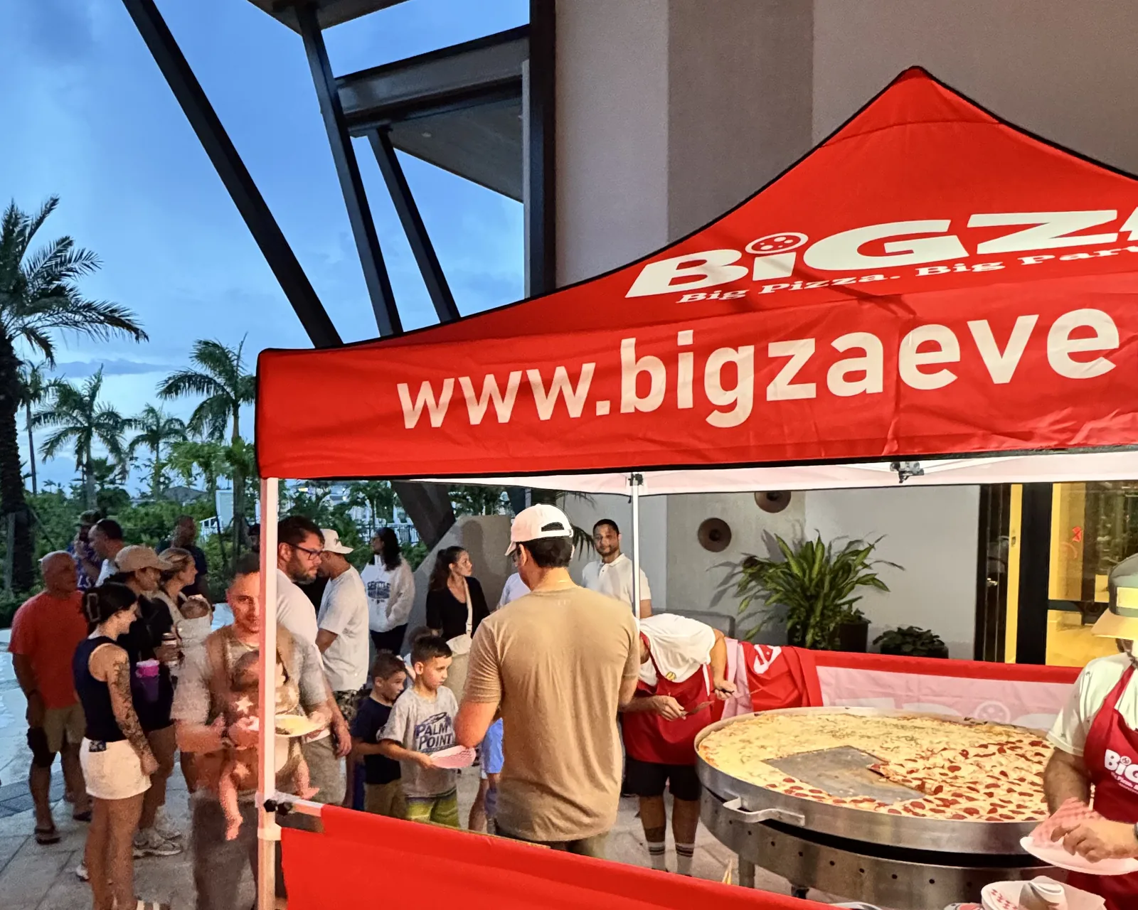 How big is Bigza? Size comparisons showing the 5-foot pizza next to a banana, an adult, a car and more — 3 of 4